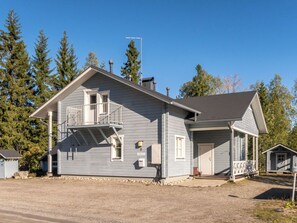 A two-story house with a balcony, a garage, and a small shed. - Jeskatti by Interhome (Sotkamo)
