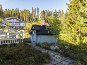 A cabin with a stone roof, surrounded by dense forest. - Jeskatti by Interhome (Sotkamo)