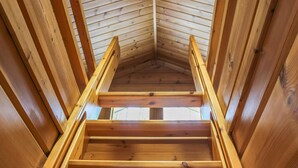 A wooden staircase in a cabin with a sloped ceiling. - Hamppulahti by Interhome (Kuhmo)