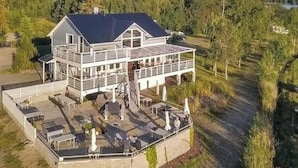 A two-story house with a balcony and outdoor seating area. - Hästöskata a by Interhome (Kruunupyy)