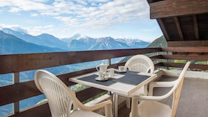 A table and chairs set on a balcony with a mountain view. - Zurschmitten 17 1. OG Süd by Interhome (Riederalp)