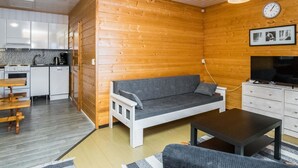 A compact living space with a kitchenette, a sofa, a TV, and a dining area. - Lepikko by Interhome (Kaavi)