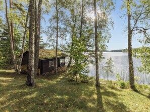 A cabin by a lake surrounded by trees. - Koivuranta by Interhome (Kirkkonummi)