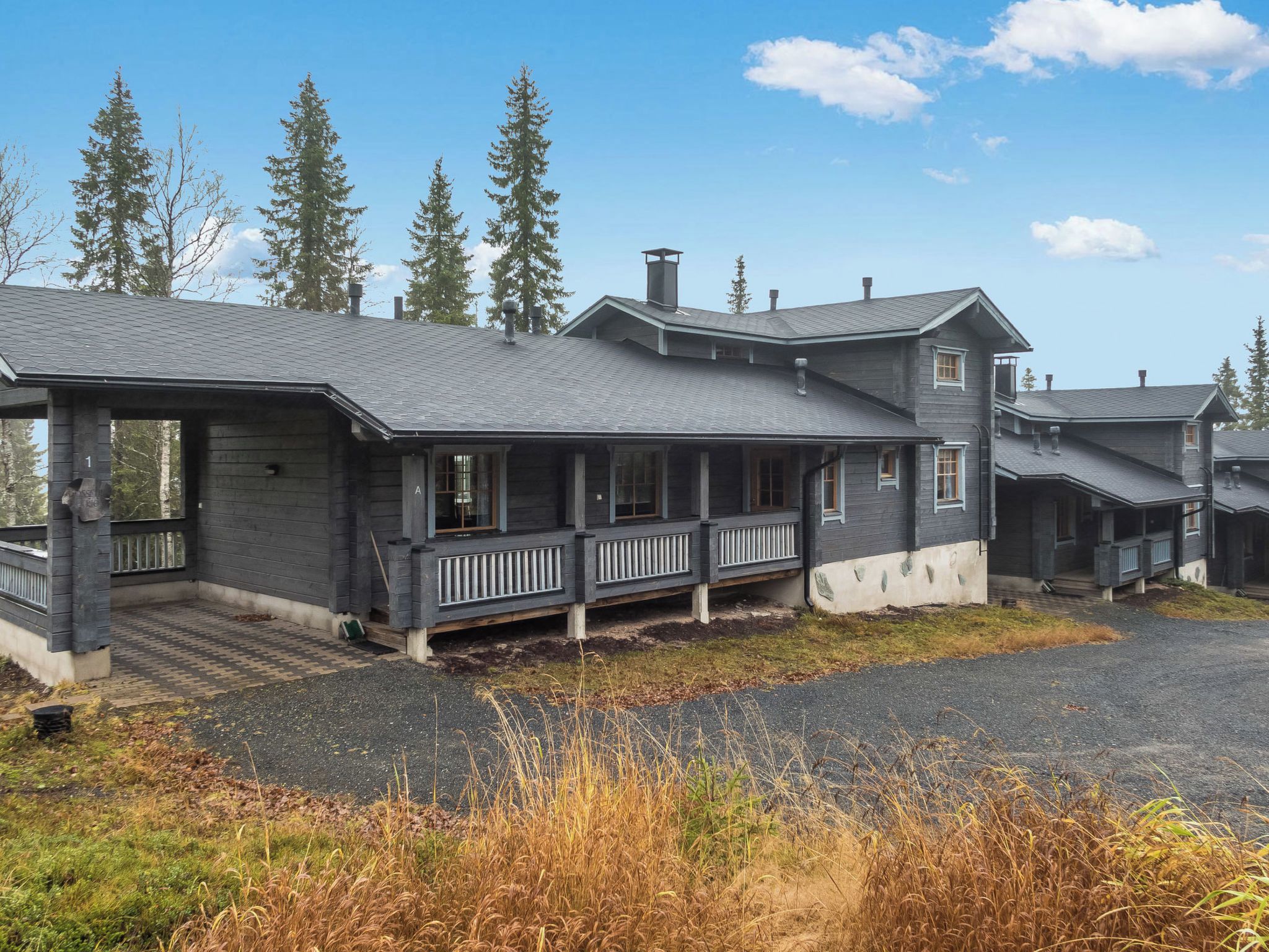 A two-story house with a covered porch and a garage.