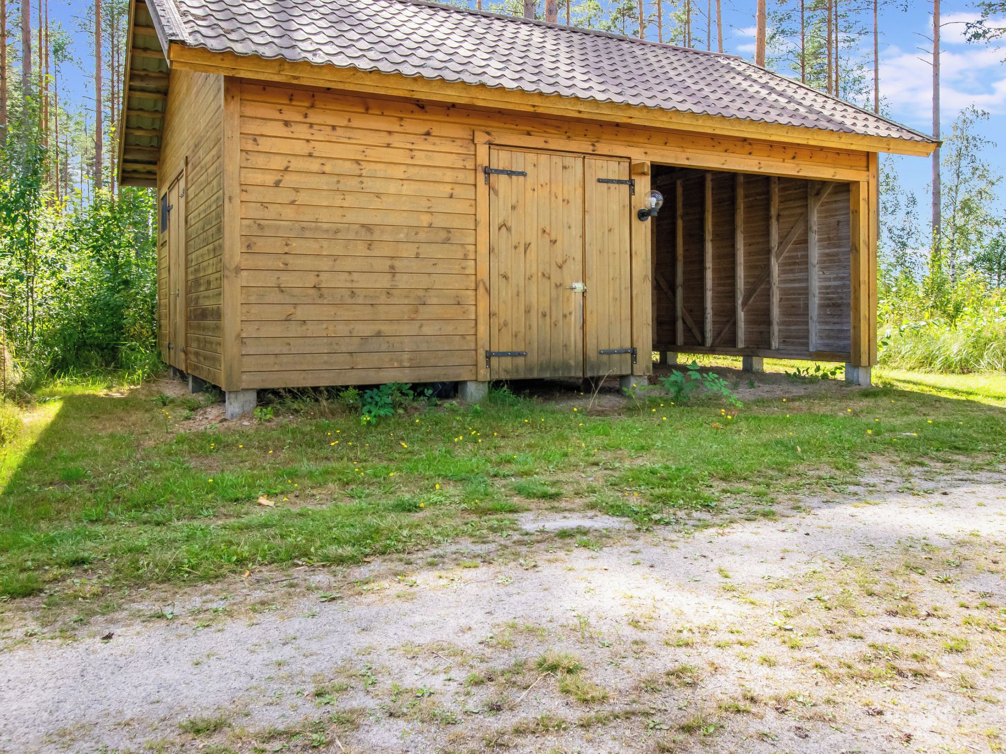 A wooden cabin with a tiled roof, a door, and a window.