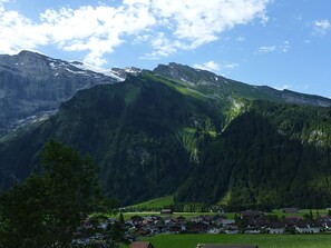 A mountainous landscape with a village at the base.