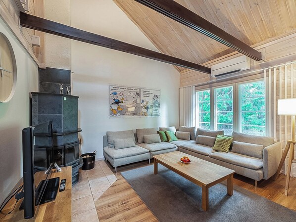 A modern living room with a fireplace, a sofa set, and a coffee table.