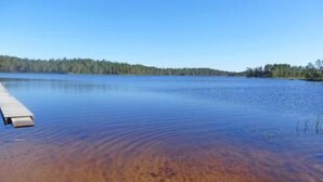 A calm lake with a wooden dock extending into the water. - Takaharju by Interhome (Posio)
