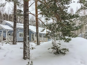 A house surrounded by snow-covered trees.