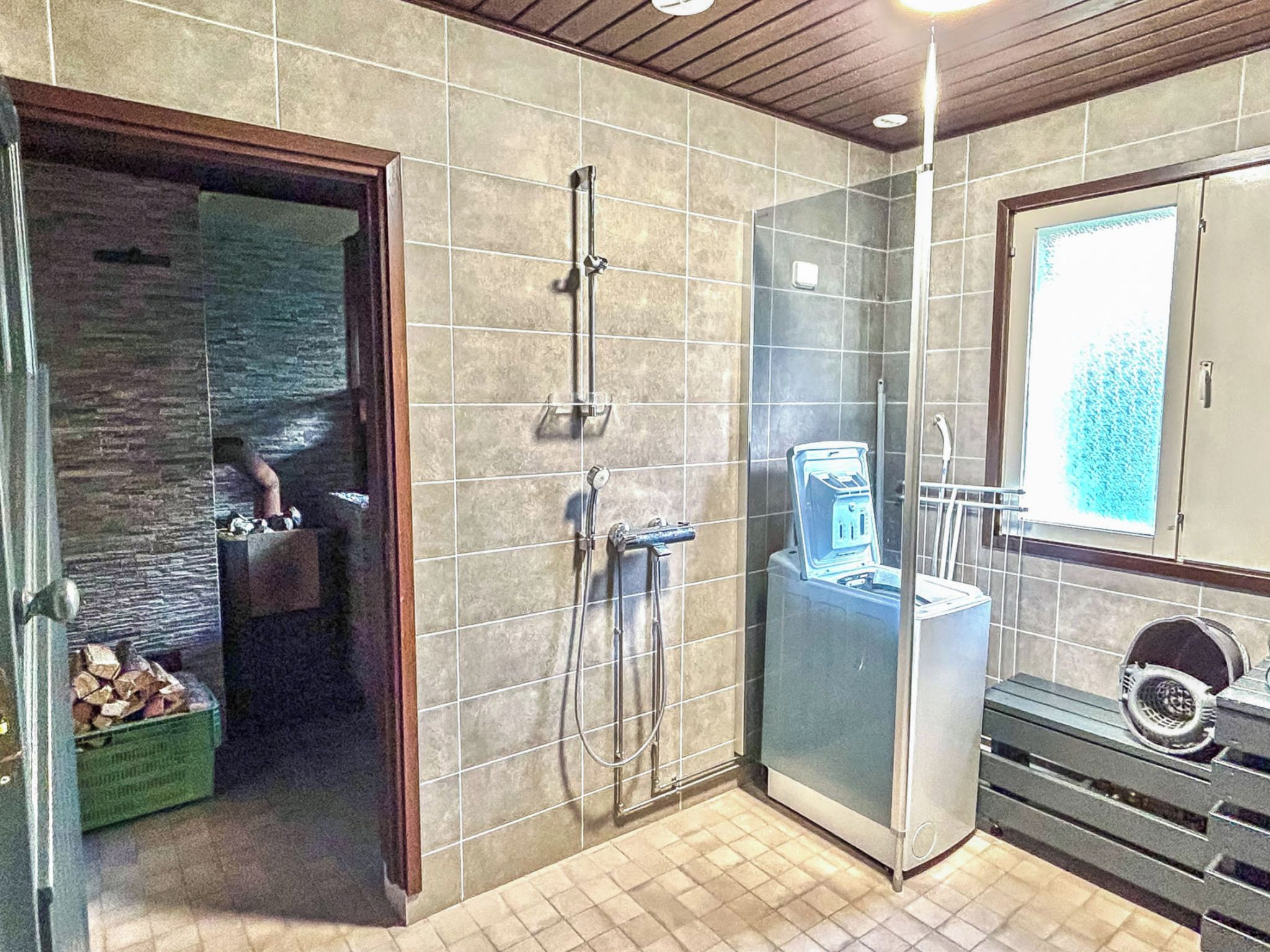 A modern bathroom with a shower, a toilet, and a sink.