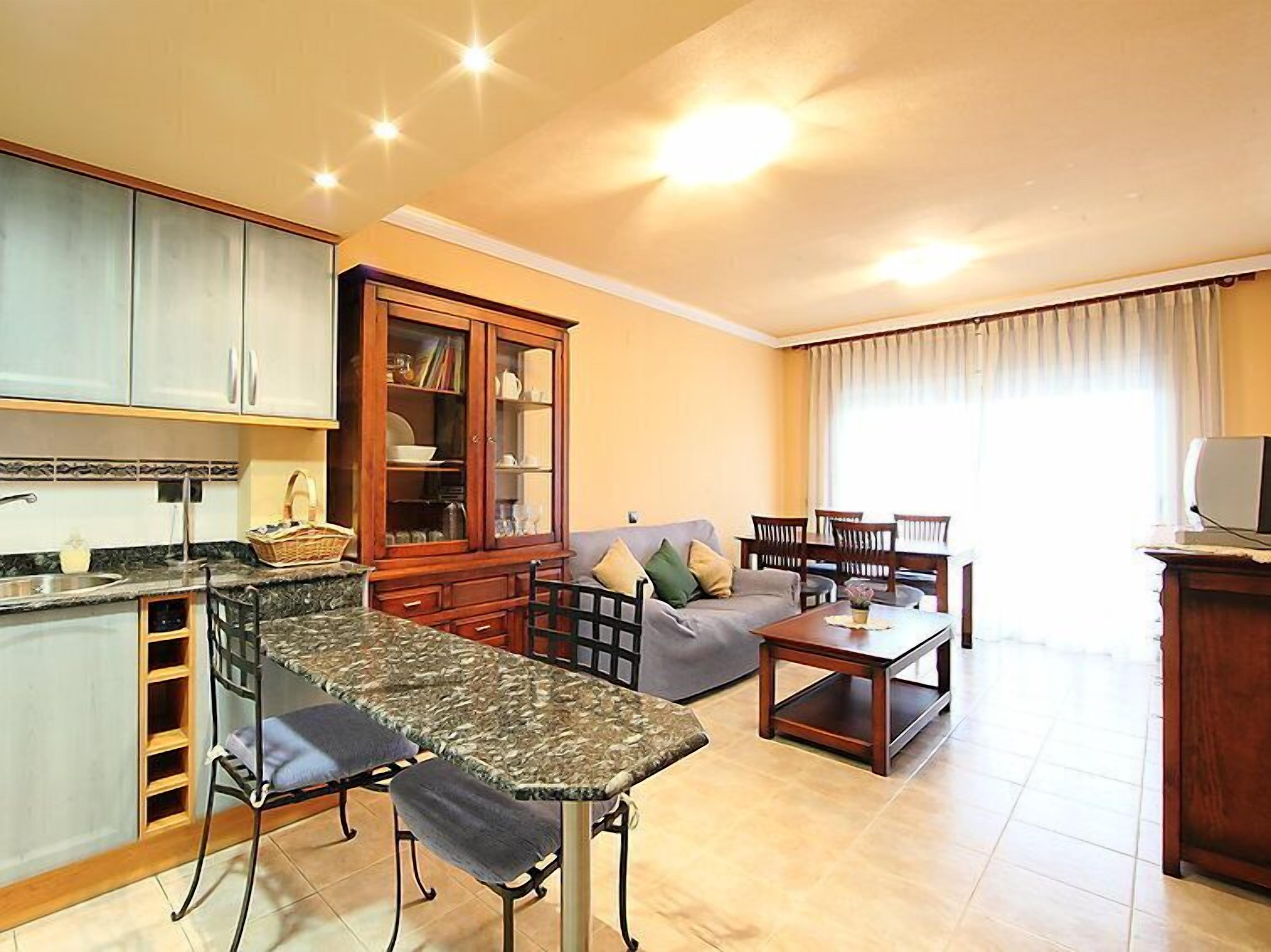A compact living space with a kitchen, dining area, and seating.