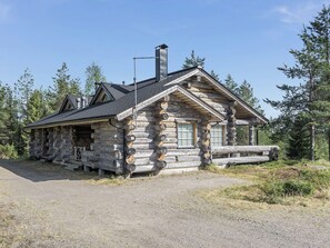 A log cabin with a chimney, a window, and a door. - Kelovalta 7b by Interhome (Kuusamo)