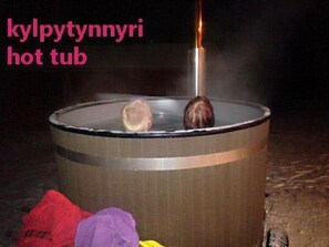 Relax in a hot tub surrounded by a serene outdoor setting.