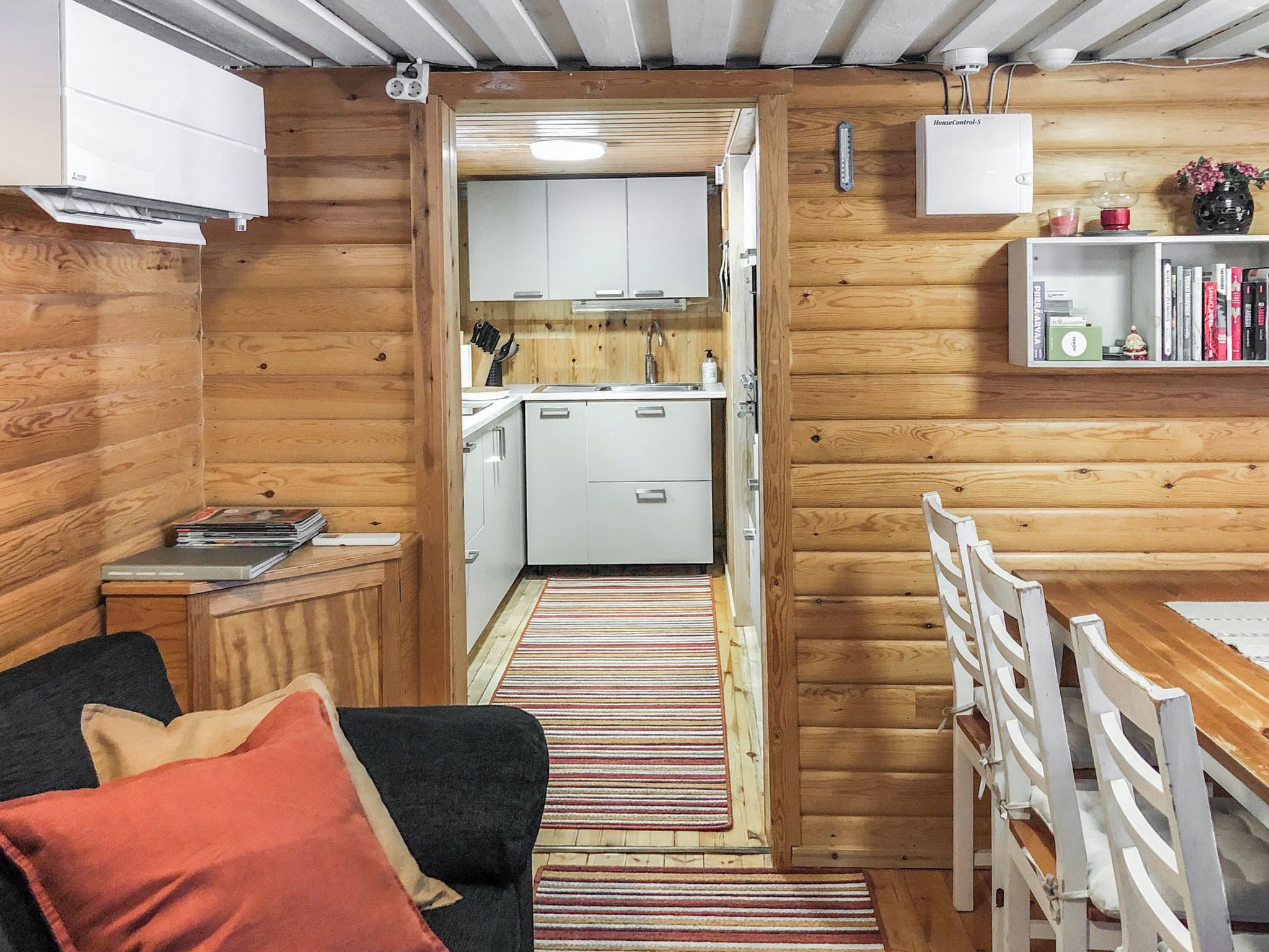 A compact living space with a kitchenette, a dining area, and a small seating area.