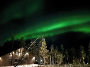 A cabin with a view of the northern lights.