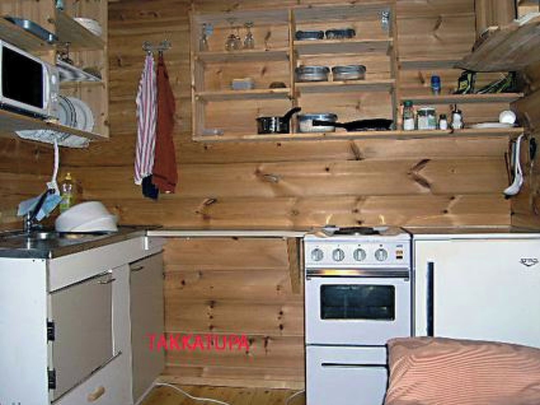 A compact kitchen with a stove, oven, and microwave.