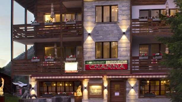 A multi-story building with a restaurant named "Channia" on the ground floor. - Apartment Channa by Interhome (Saas-Almagell)