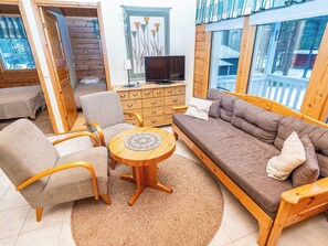 A cozy living room with a sofa, chairs, a coffee table, and a TV. - Villa valokki by Interhome (Kuusamo)