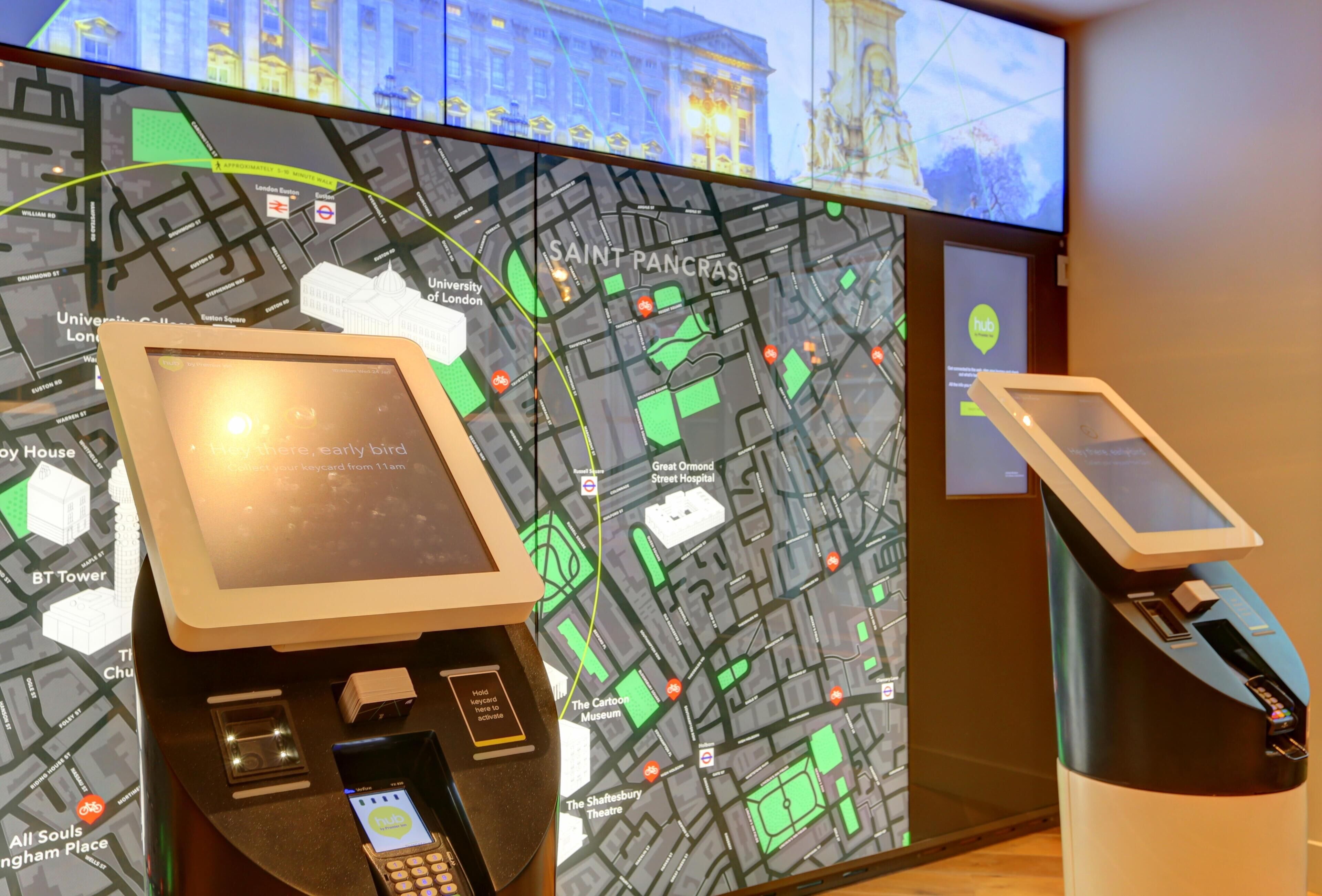 A digital map display with a kiosk, a smartphone, and a payment terminal.