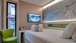 A hotel room with a bed, a television, a map on the wall, and a green chair. - Hub By Premier Inn London City Bank (London)