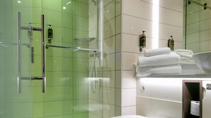 A modern bathroom with a glass-enclosed shower, a white toilet, and a glass shower door. - Hub By Premier Inn London City Bank (London)