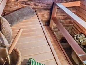 A wooden floor with a striped rug, a woven basket, and a green and white striped object.
