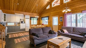 A cozy cabin interior with a kitchen, dining area, and living room. - Metsäpirtti by Interhome (Parkano)