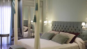 A bedroom with a large bed, a bedside table, a chair, a mirror, and a canopy. - Posada Suiza by Prima Collection (San Miguel del Monte)
