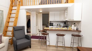 A loft-style apartment with a kitchen, a dining area, and a living room. - Koivukuja, katinkullantie by Interhome (Sotkamo)