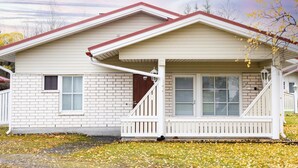A single-story house with a red roof, white siding, and a front porch with a staircase. - Koivukuja, katinkullantie by Interhome (Sotkamo)