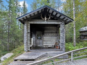 A rustic cabin with a wooden exterior, a porch, and a small staircase leading up to the entrance. - Vacation home Kivelä by Interhome (Kuusamo)