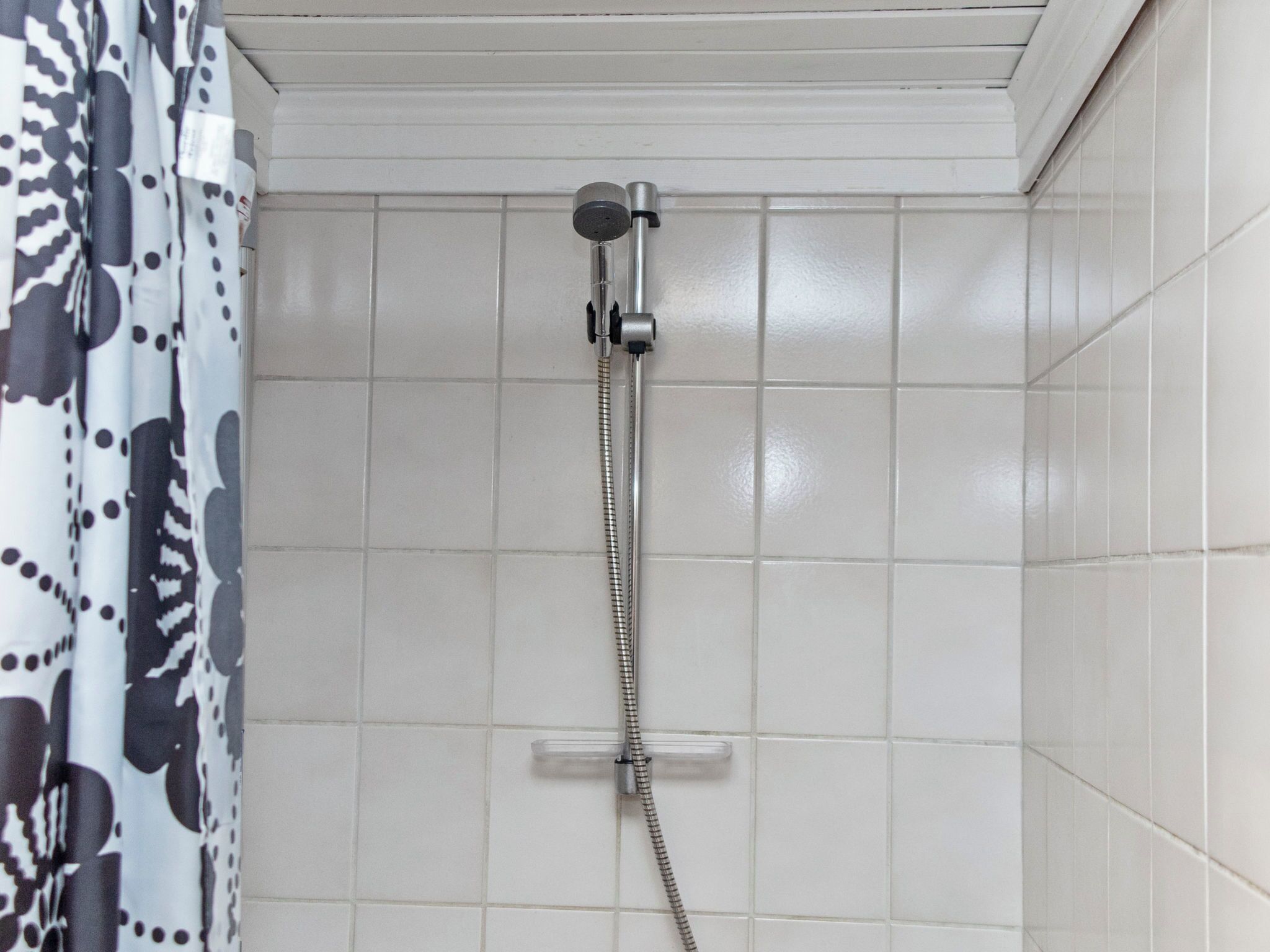A shower with a handheld showerhead, a control lever, and a flexible hose.