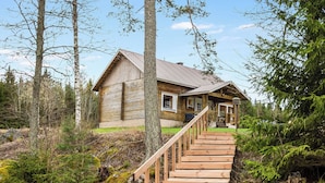 A wooden cabin with a staircase leading to a porch. - Pihlaja by Interhome (Hämeenlinna)