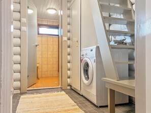 A laundry room with a washing machine, a drying rack, and a tiled floor. - Pihlajakumpu by Interhome (Petäjävesi)
