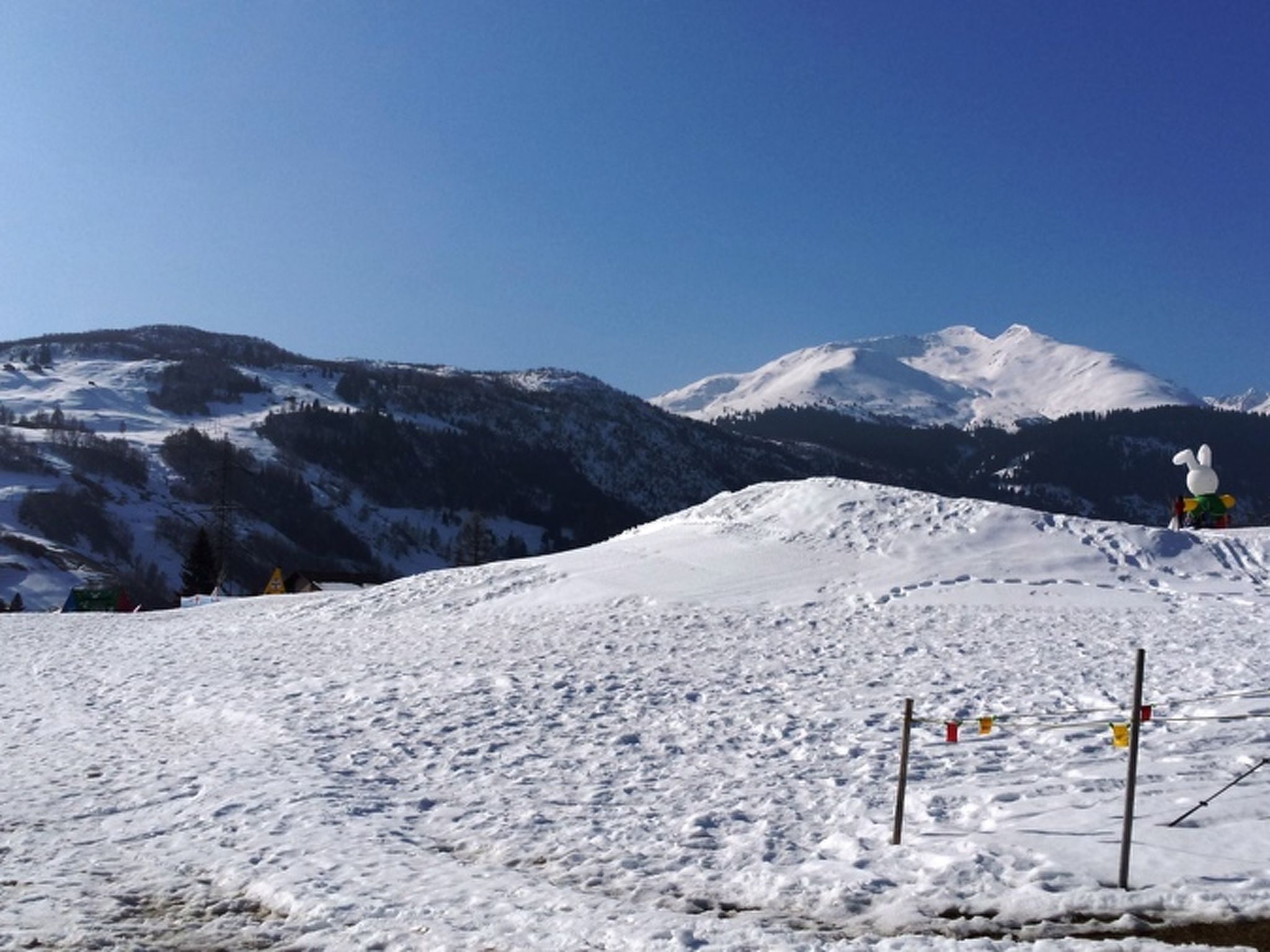 A snowy mountain landscape with a clear sky.