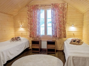A room with two beds, a desk, and a window with curtains. - Villa sofia by Interhome (Sotkamo)
