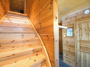 A wooden staircase leading to a room with a map on the wall. - Luppoaika by Interhome (Kuusamo)