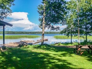 A lakeside picnic area with a dock, picnic table, and a covered pavilion. - Långstrands stuga by Interhome (Raasepori)