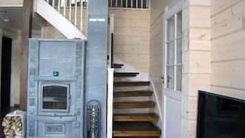 A staircase with wooden steps and white railings leading to a second floor.
