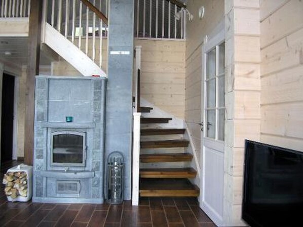 Una escalera de madera con barandillas blancas que sube a un segundo piso.