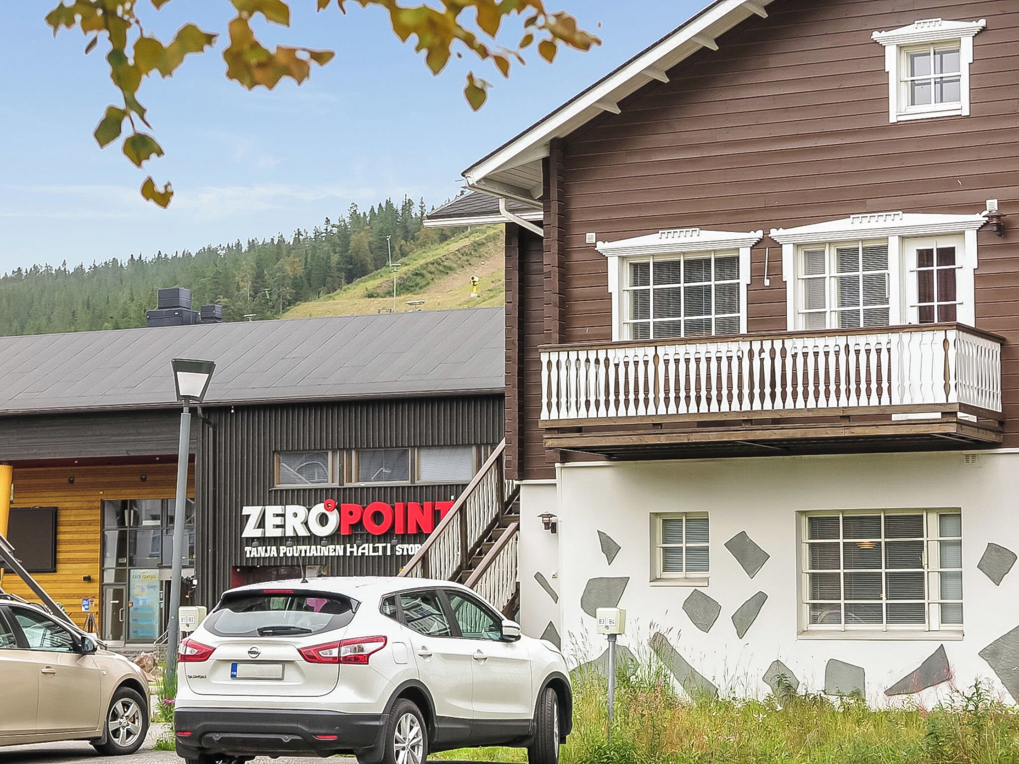 A building with a balcony and a sign that reads 'ZEROPOINT'.