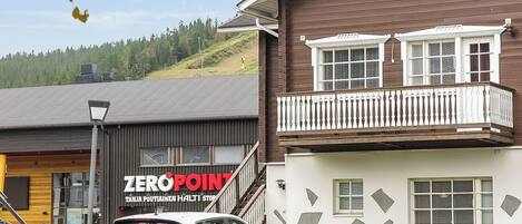 A building with a balcony and a sign that reads 'ZEROPOINT'.