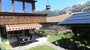A wooden house with a balcony, a hanging pot, and a solar panel. - Apartment Bolgen by Interhome (Zweisimmen)