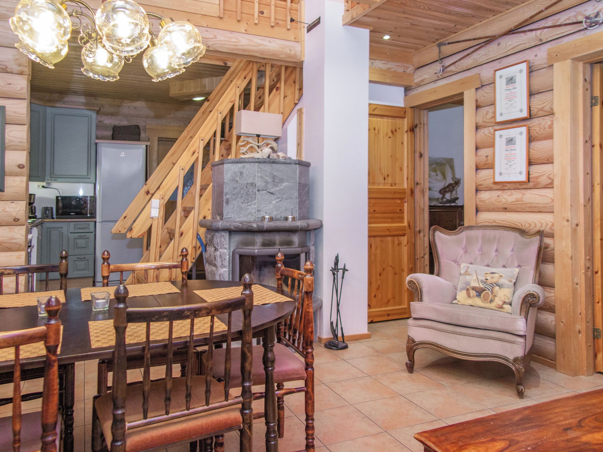 Un intérieur en bois comprenant un coin repas, une cheminée et un escalier.