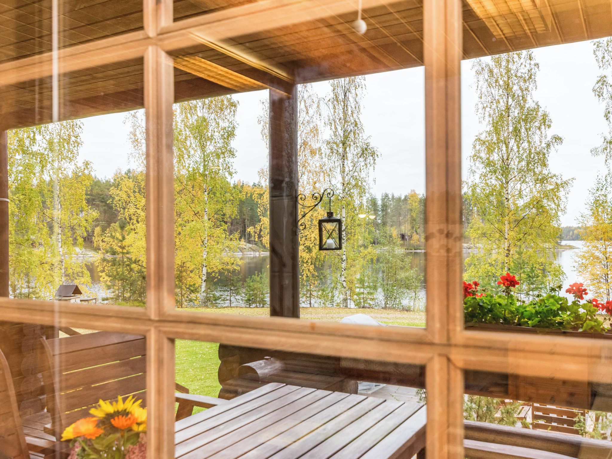 Una cabaña de madera con vista a un lago y árboles.