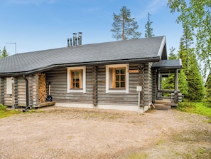 A log cabin with two windows and a chimney, surrounded by trees. - Kieppi b by Interhome (Kuusamo)