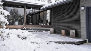 A modern building with large windows and a covered outdoor area.