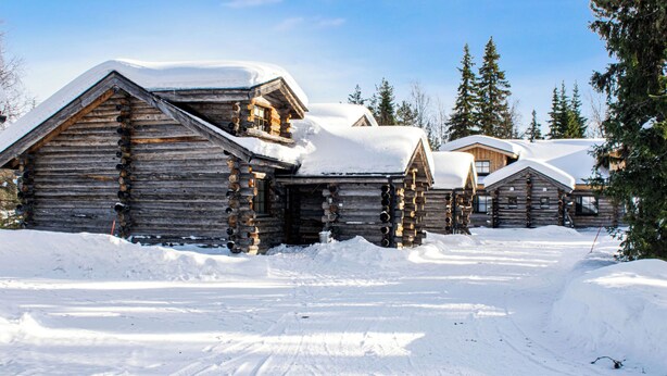 A log cabin with a snow-covered roof, surrounded by snow, with a clear sky. - Kantapää d2 by Interhome (Sodankylä)