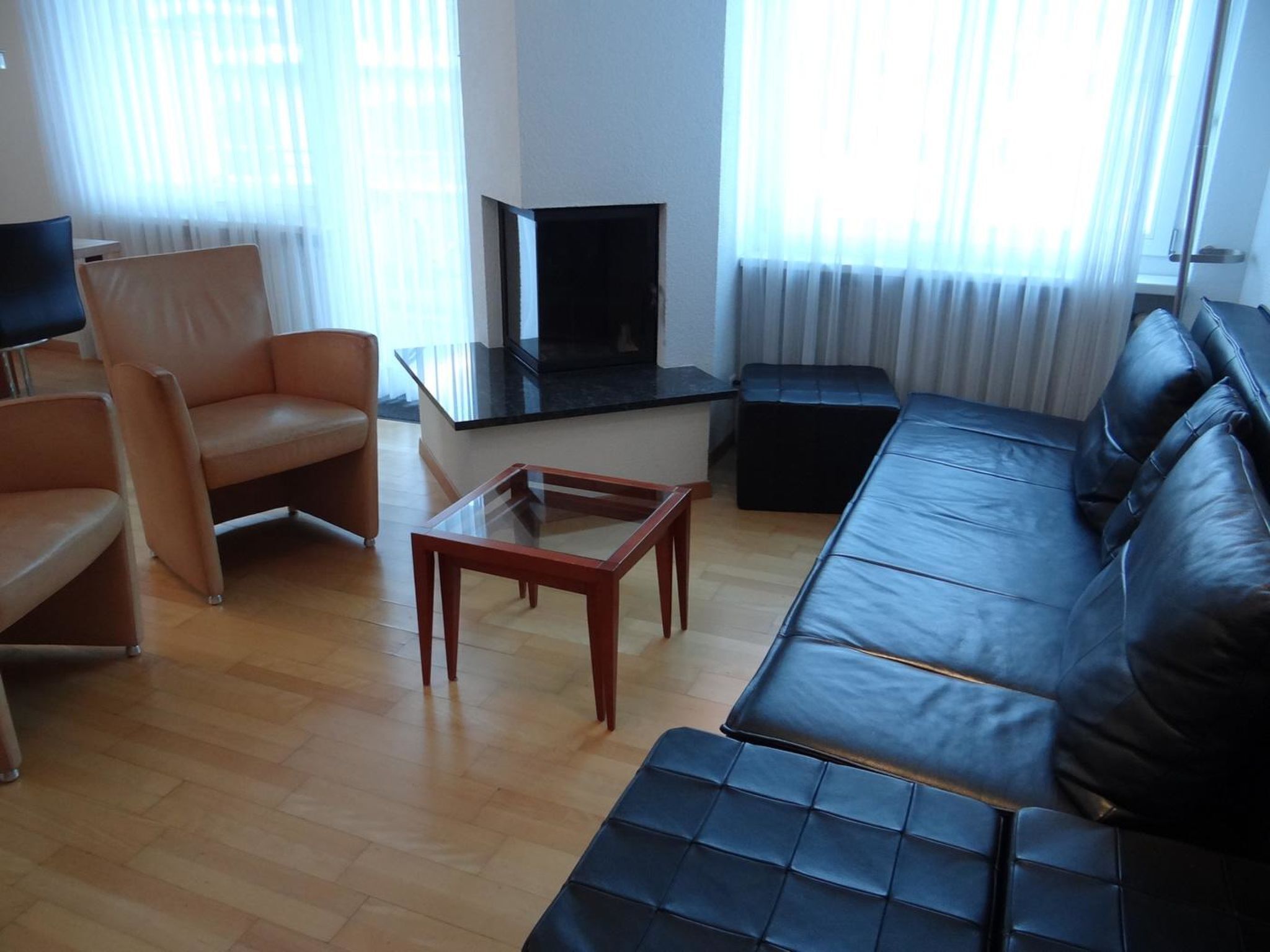 A living room with a sofa, armchair, and a coffee table.