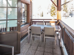 A balcony with a table and chairs, a wooden railing, and a window with blinds. - Point vale 2 as 5 by Interhome (Nilsiä)